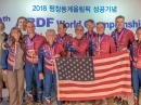 ARDF Team USA 2018 members display their medals. (Front, from left to right) Alla Mezhevaya; Vadim Afonkin, KB1RLI; Ruth Bromer, WB4QZG; Joseph Huberman, K5JGH; Ken Harker, WM5R, and Lori Huberman. (Rear, from left to right) Bob Cooley, KF6VSE; Eduard Nasybulin; Nicolai Mejevoi; Bill Wright, WB6CMD, and Joseph Burkhead. [Mindy Johnson photo]